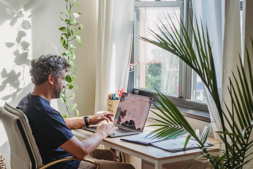 form 8829 man sitting at home office desk working on laptop